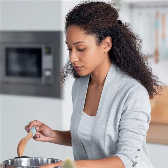woman cooking soup