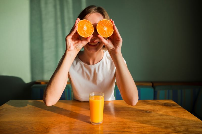 mujer con media naranja en cada ojo